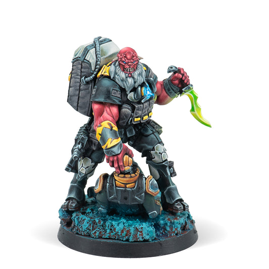 A miniature figure of a Krakot Renegade equipped with two submachine guns and a chest mine, standing on a base with blue terrain effects.