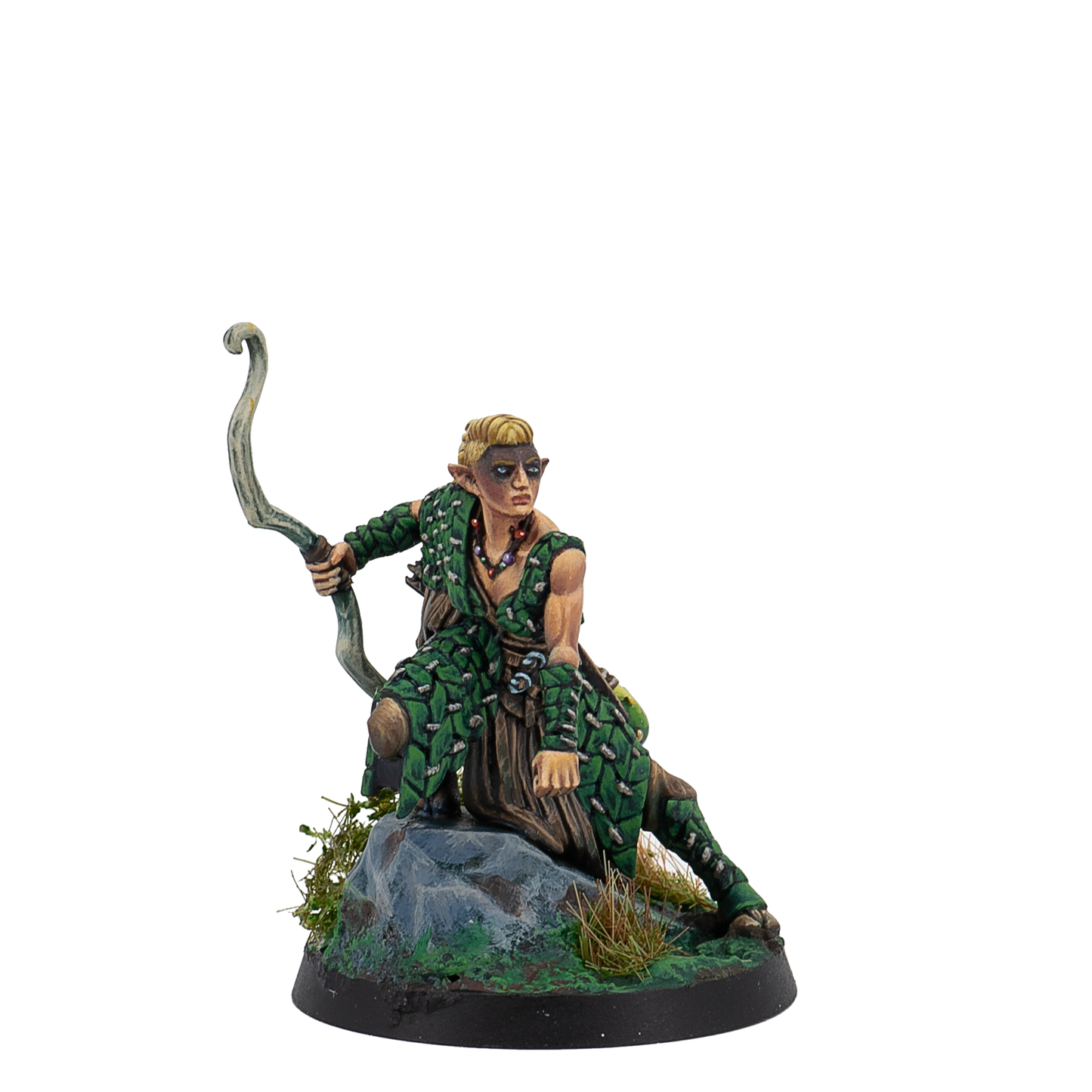 Figurine of a character in green attire with a bow, sitting on a rock with a white background