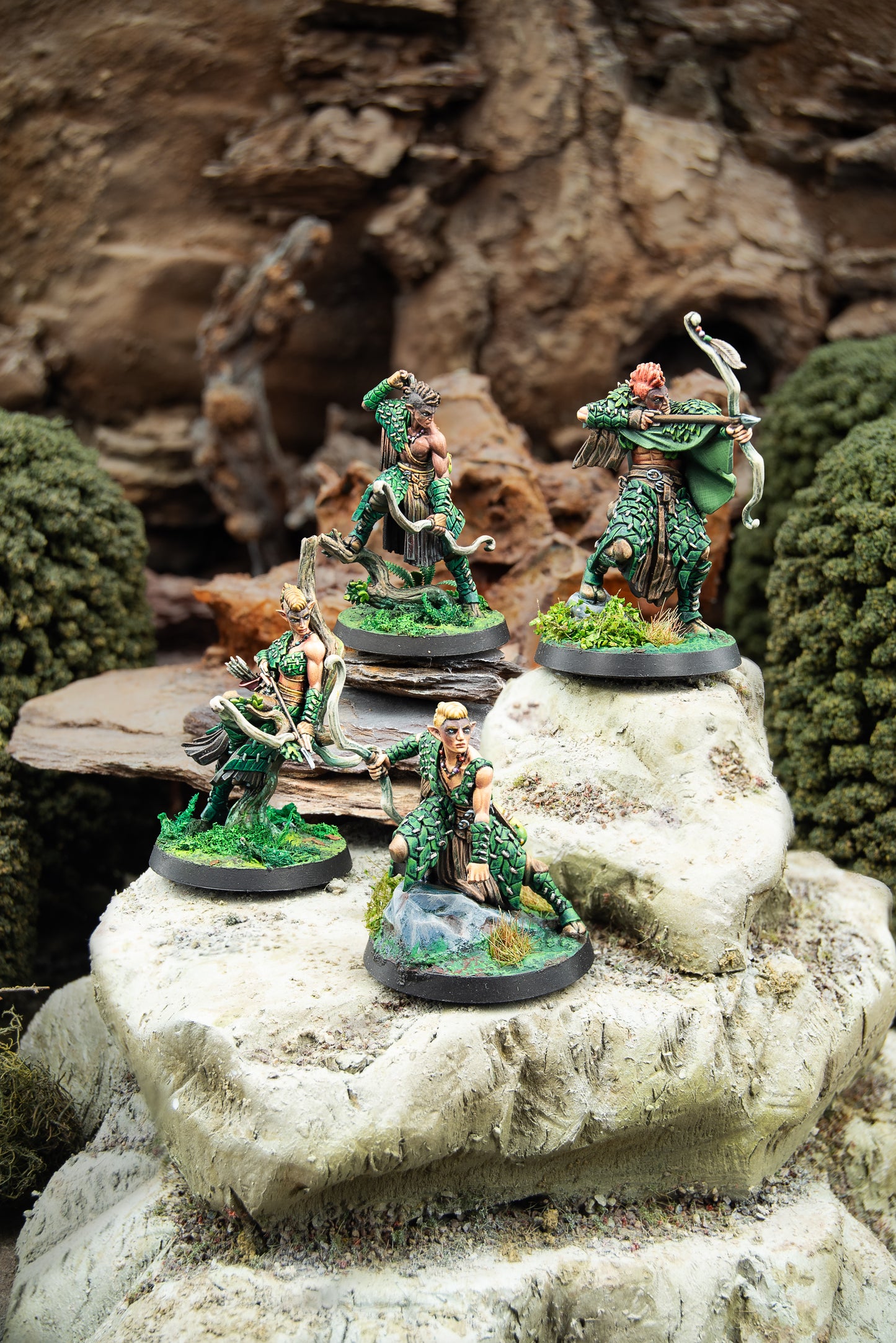 Miniature figurines of green-skinned warriors on rocky terrain