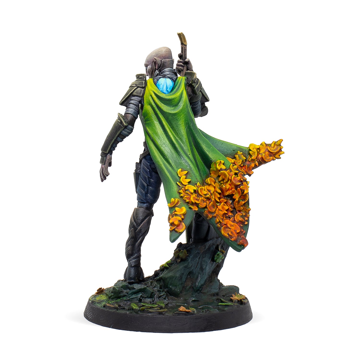 Fantasy figurine with a green cloak and orange flowers on a white background