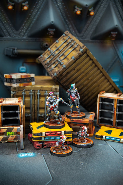 Toy figures on a dark surface with wooden crates and shelves in the background